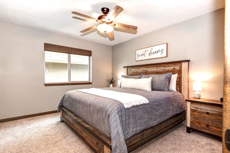 The master bedroom on the main floor features a large walk-in closet (perfect for a Pack 'n Play), king bed, Smart TV, iHome, and full bathroom